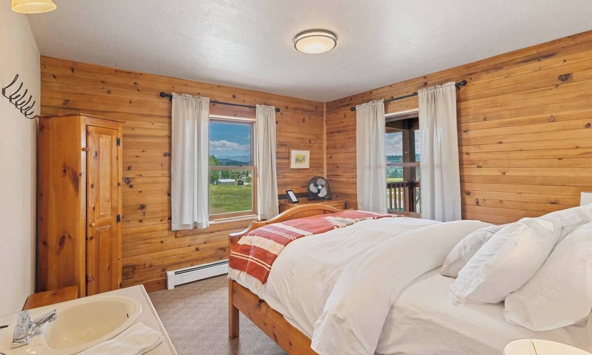 Clark Cabin | Comfortable private queen room in the True North Adventure Lodge. Includes a queen bed, private ensuite bathroom, and access to shared amenities like the kitchen, great room, and hot tub. Great for couples or solo travelers.