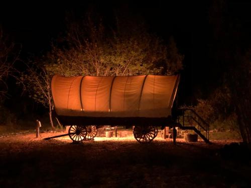 Murphy Other | Cozy Wild West Covered Wagon next to River