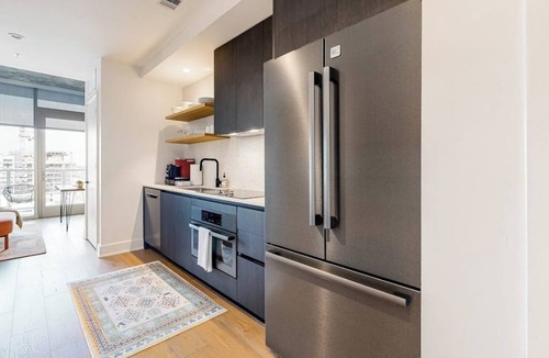 Rainey Street Historic District Apartment | Austin studio condo with WiFi, balcony, W/D, full kitchen, rooftop pool, & gym