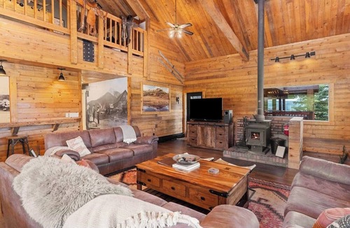 Clark Cabin | Comfortable private queen room in the True North Adventure Lodge. Includes a queen bed, private ensuite bathroom, and access to shared amenities like the kitchen, great room, and hot tub. Great for couples or solo travelers.