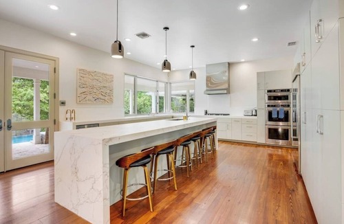 Hunt House | Inviting waterfront home with pool, patio, fireplace, W/D, & dog-friendly