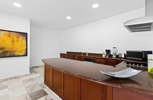 Conchas Chinas Apartment | Modern hillside suite with balcony, city view, pools, gym & full kitchen