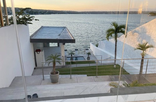 Tequesquitengo House | Modern Lakeside Retreat: Beach Access, All-White Tile, & Stylish Décor