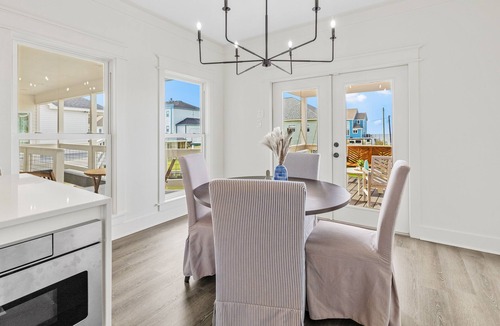 Creole House | Modern waterfront home with boat lift, dock, game tables, kayak, & AC
