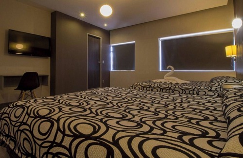 Centro Hotel | Relax in Two Bright Fun Rooms Close to Culture, Food, and Fun Spots