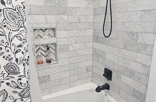 Duncan Apartment | Serene large bedroom with private entrance, bathroom, and thermostat.