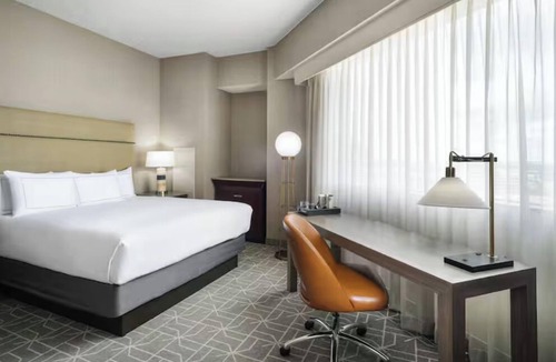 Richardson Hotel | Sip, Splash & Shuffleboard Fun: Your Perfect Poolside Retreat with Free Shuttle