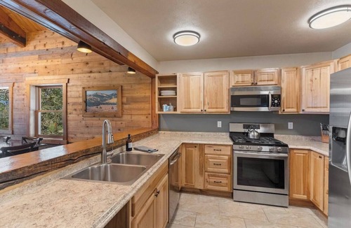 Clark Cabin | Spacious private king suite in the True North Adventure Lodge. Includes a king bed, private ensuite bathroom, and access to shared lodge amenities like the kitchen, great room, and hot tub. Ideal for couples or guests wanting extra space.