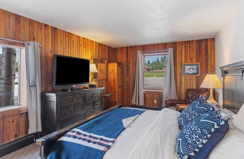 Clark Cabin | Spacious private king suite in the True North Adventure Lodge. Includes a king bed, private ensuite bathroom, and access to shared lodge amenities like the kitchen, great room, and hot tub. Ideal for couples or guests wanting extra space.