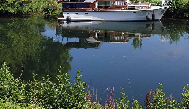 Atypical and cozy moored dutch boat on the Somme river in Eaucourt-sur-Somme