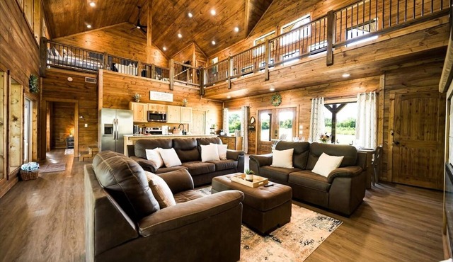 Rustic cabin on a quiet stretch of the Glover River. Three queen suites and a bunk loft sleep up to 13. Kayak from the backyard, soak in the hot tub, gather at the fire pit. Inside: game loft with ping pong, and Nintendo. FREE Gym at Sweat Shack.